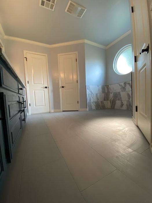 Large gray floor tile with crown molding
