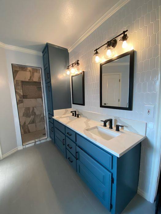 Teal double vanity in a remodeled bathroom