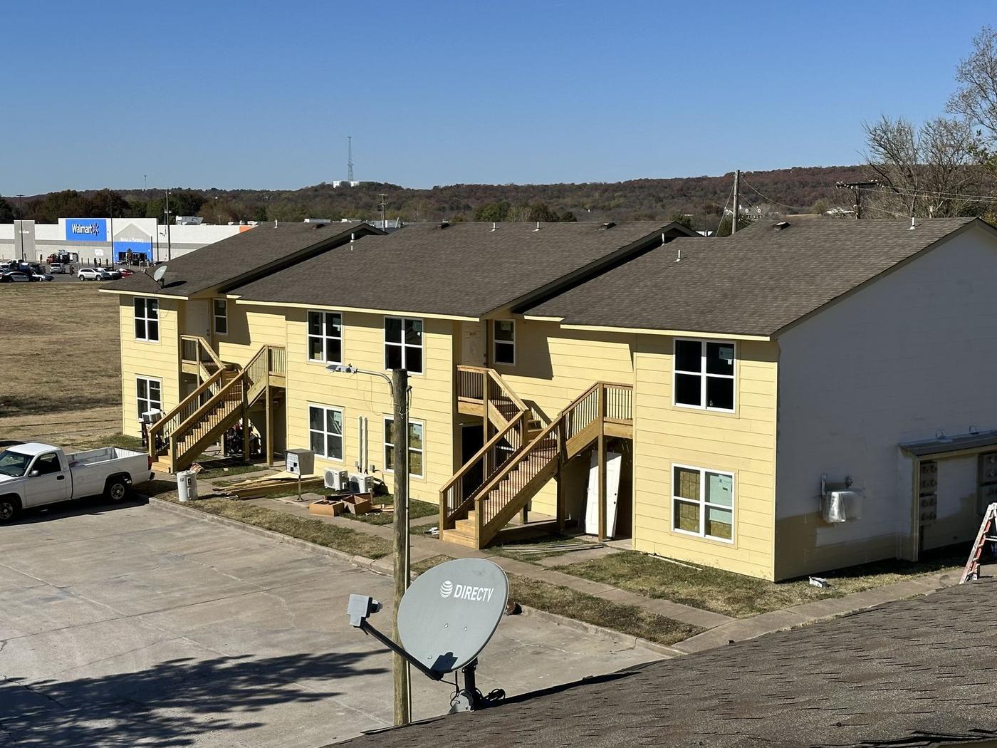 Apartment building after new lap siding, white trim, stairs and windows